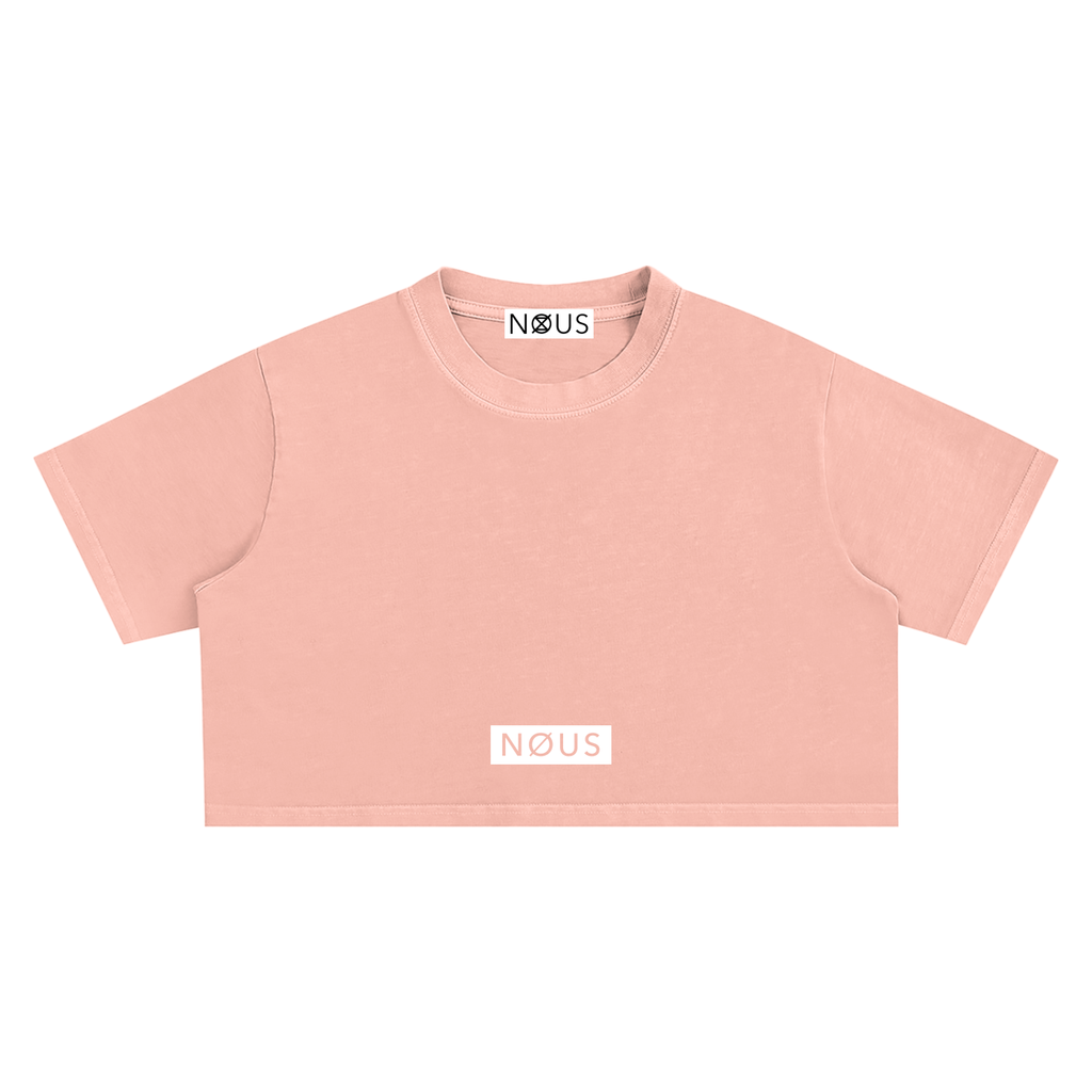 Pink crop top with 'NOUS' branding on a white background