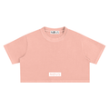 Pink crop top with 'NOUS' branding on a white background