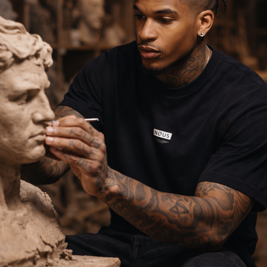 Person working on a sculpture in a workshop setting