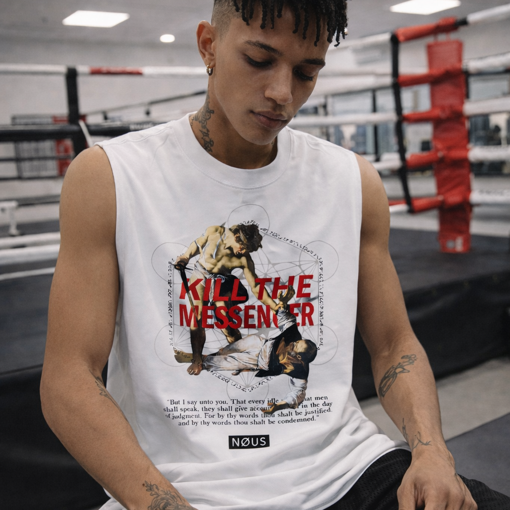 Person wearing a white sleeveless shirt with graphic design in a boxing ring.
