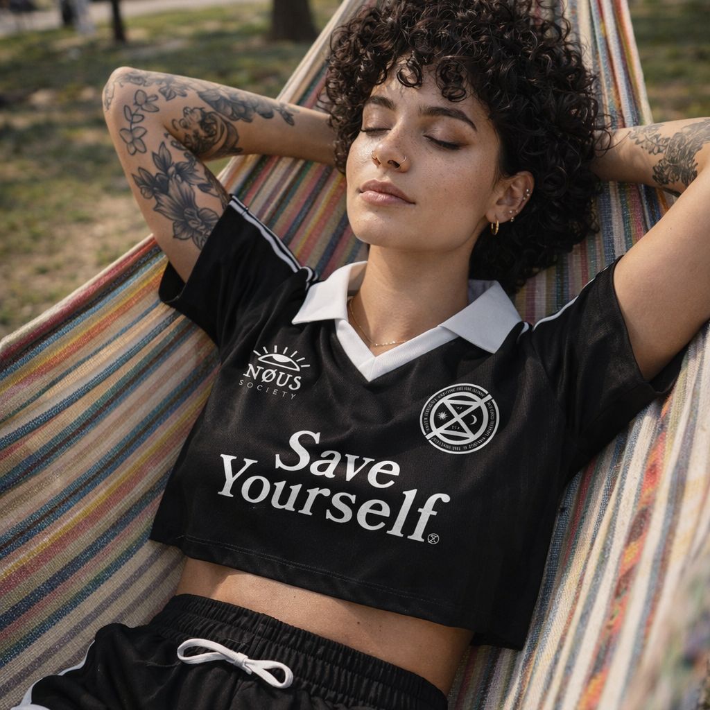 Woman wearing a black 'Save Yourself' shirt in a hammock