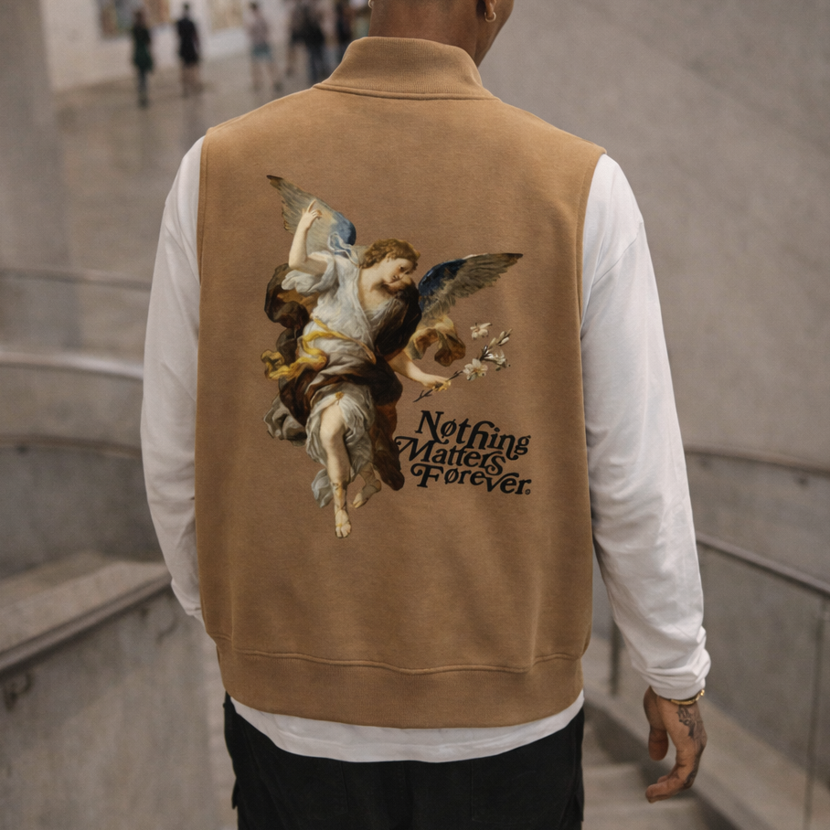 Man wearing a brown jacket with an angel design and text in an indoor setting